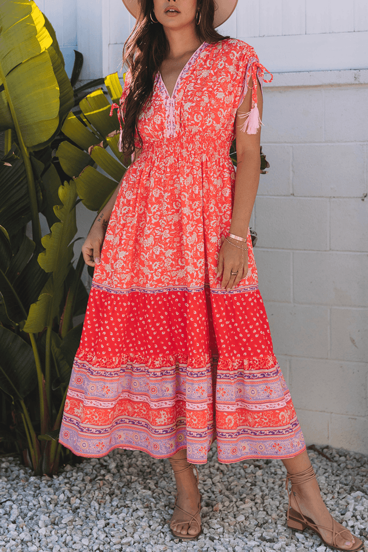 close-up front view of model in Red Floral Print Tasseled Tied Sleeve Empire Waist Maxi Dress, styled for casual summer wear