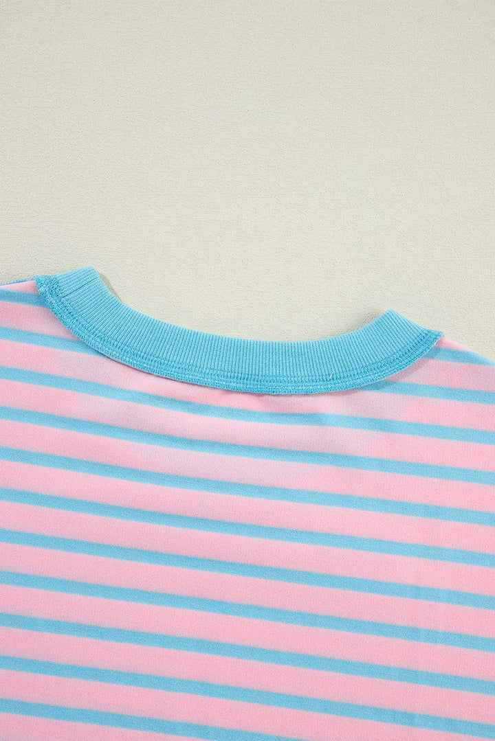 a pink and blue striped shirt laying on a table