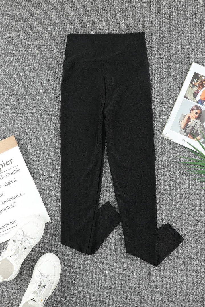 a pair of black leggings next to a magazine