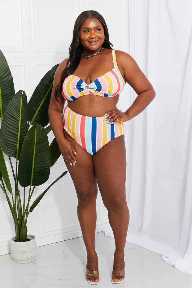 a woman in a striped bikini top and bottom