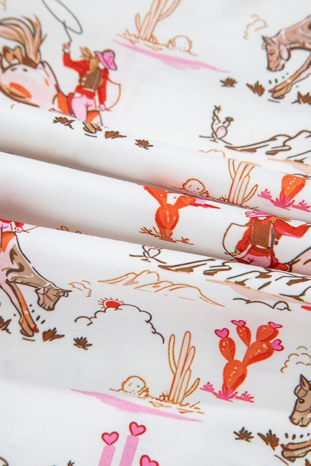 White Cowgirl Country Print Pajamas Set displayed on hanger, showing full top and shorts with pink accents. Shop White Cowgirl Country Print Pajamas Set at Faith & Co. Boutique.