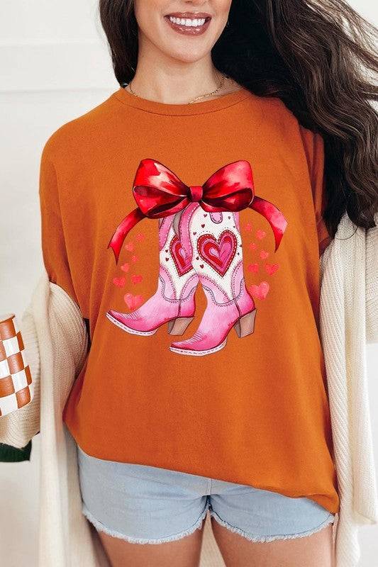 Burnt orange Valentine Cowgirl Boots Graphic Heavy Cotton Tee with heart boots and red bow, festive fashion from Faith & Co. Boutique.