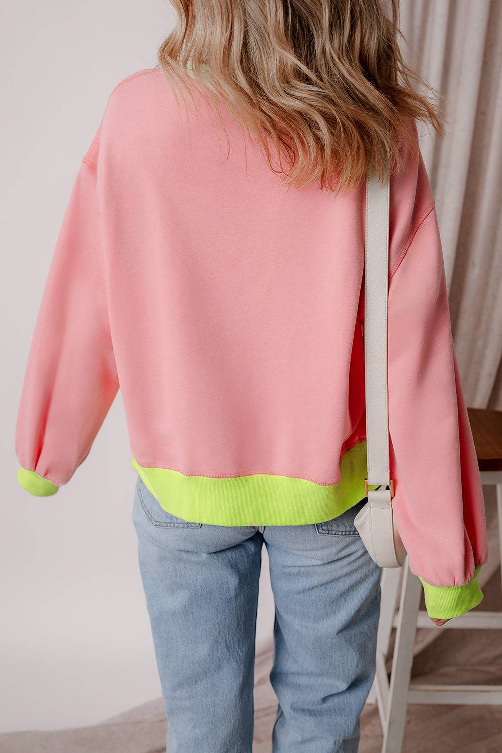 the back of a woman's pink and yellow jacket