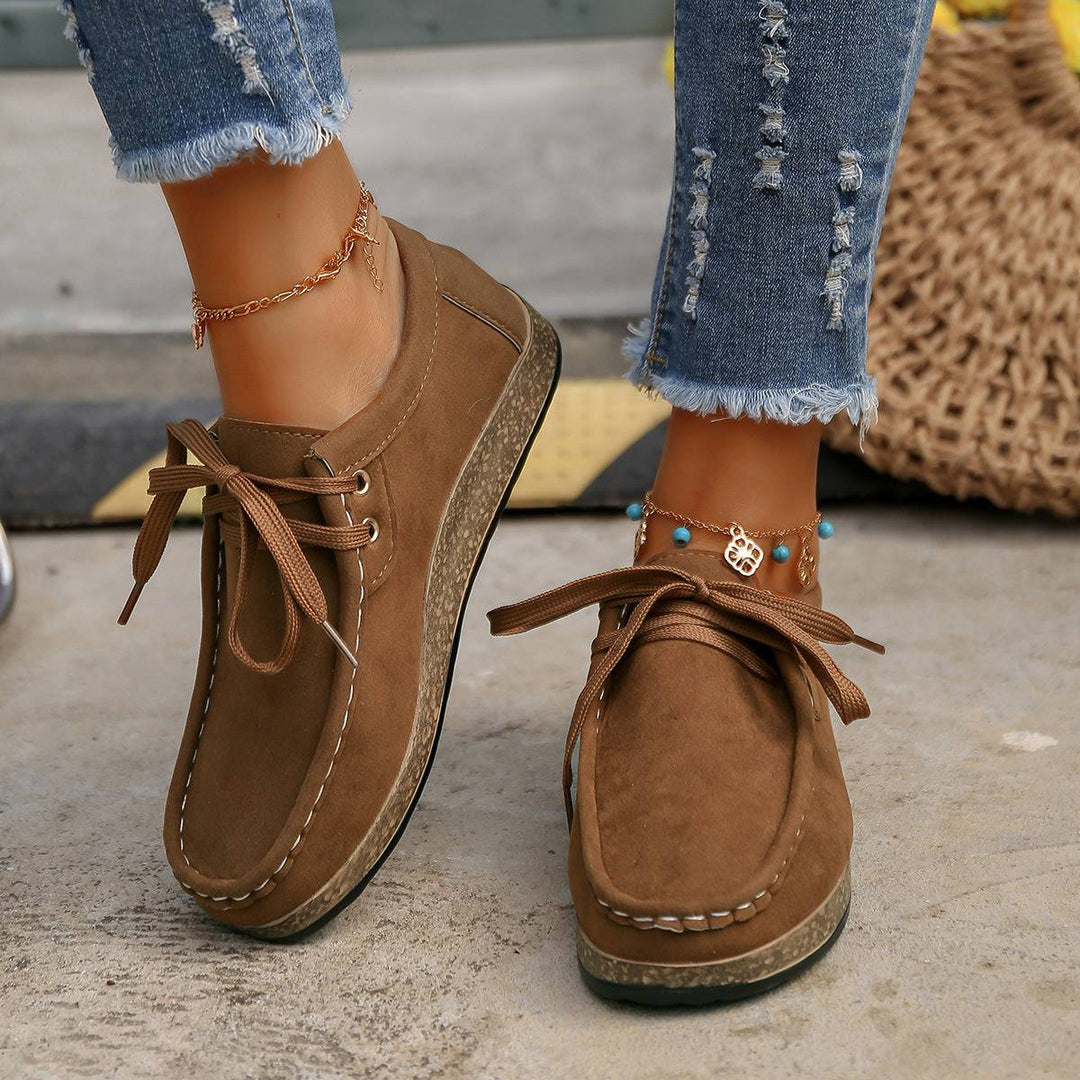 a close up of a person wearing brown shoes