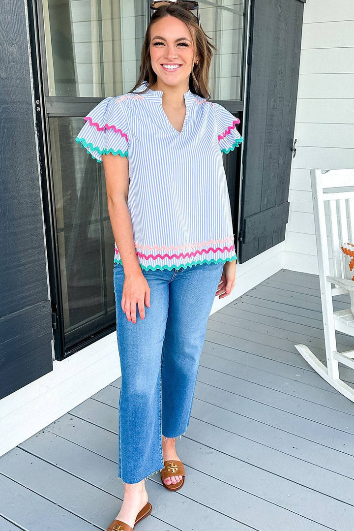 a woman standing on a porch with her hands in her pockets