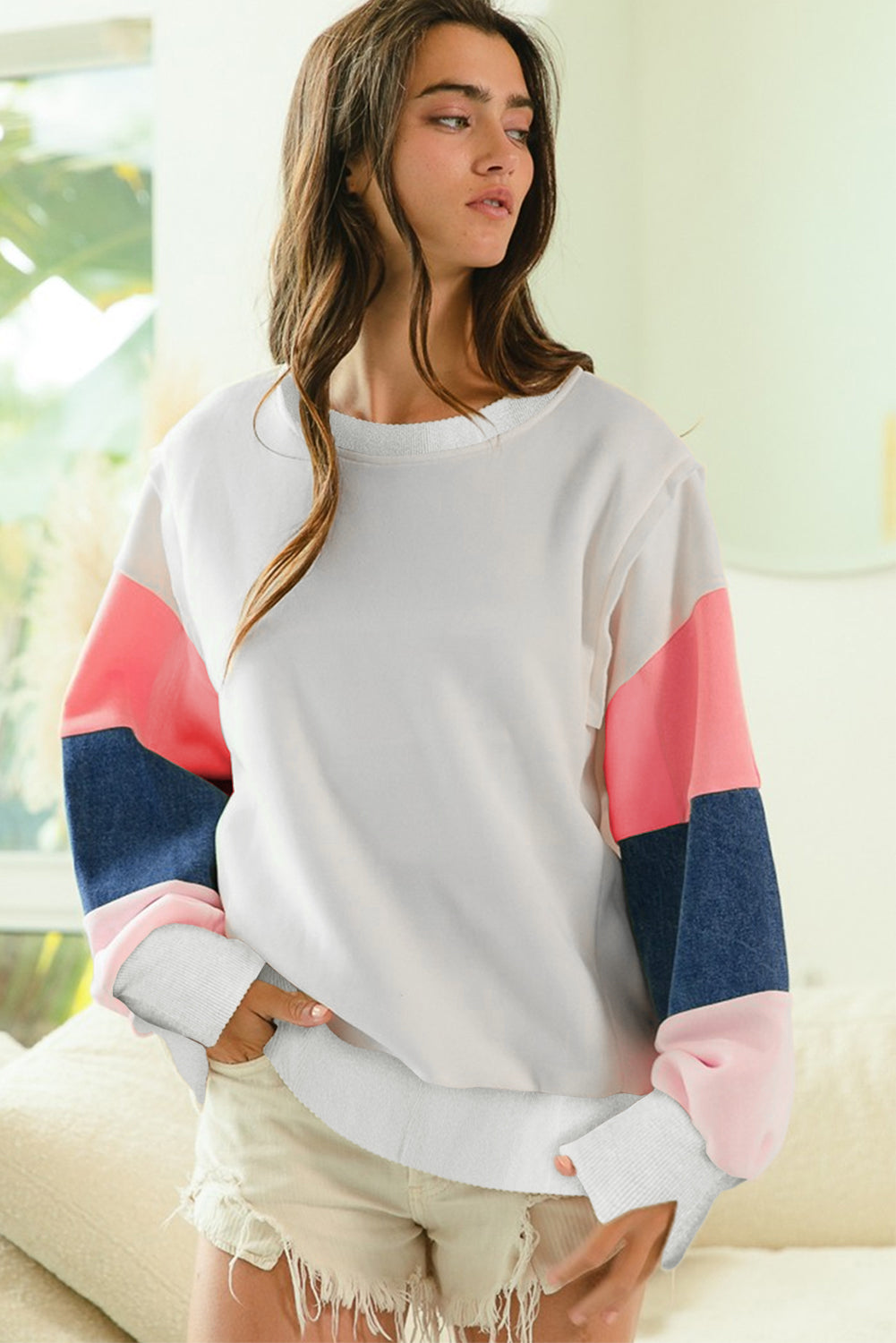 White French Terry Color Block Long Sleeve Top with pink, navy, and blush sleeves styled casually with beige shorts. Shop at Faith & Co. Boutique.