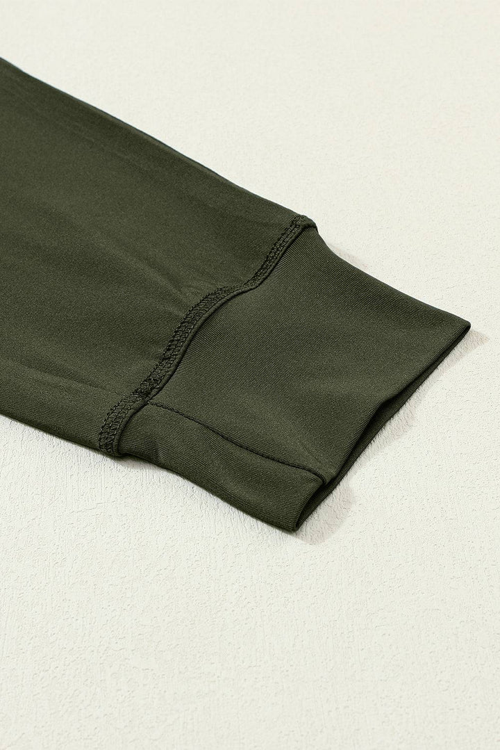 a close up of a green shirt laying on a white surface