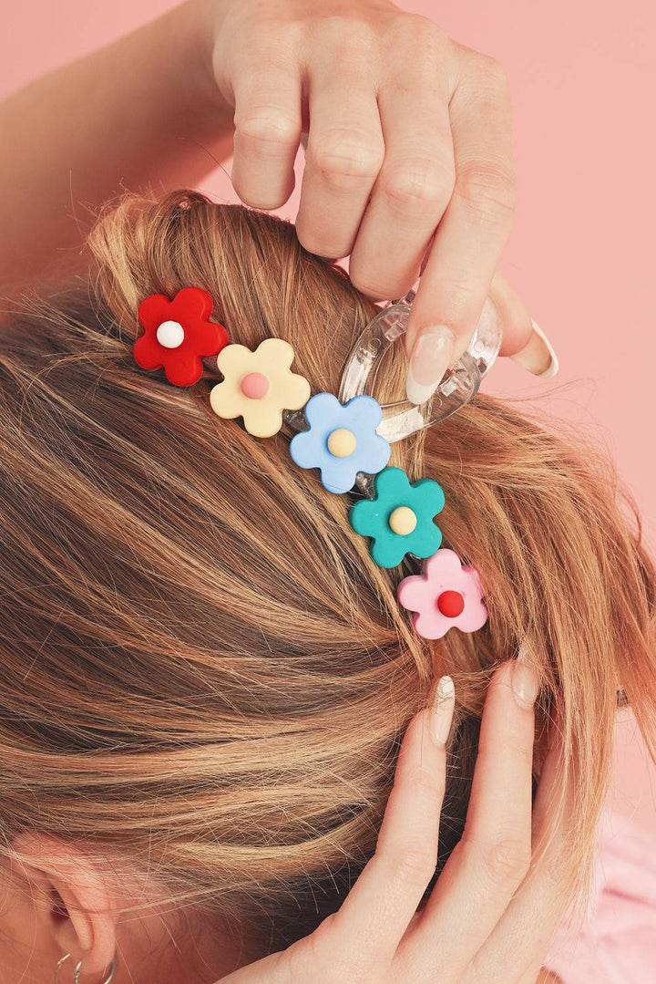 a woman with a flower hair clip in her hair