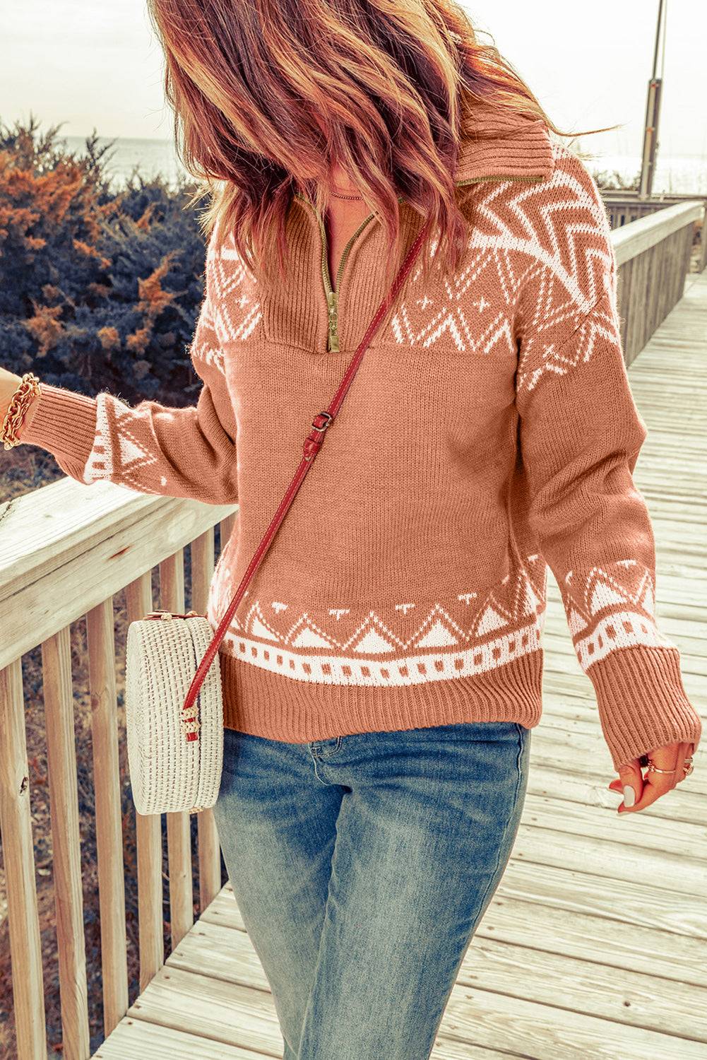 a woman is walking on a wooden bridge