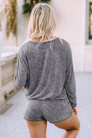 a woman in grey shorts and a grey sweater
