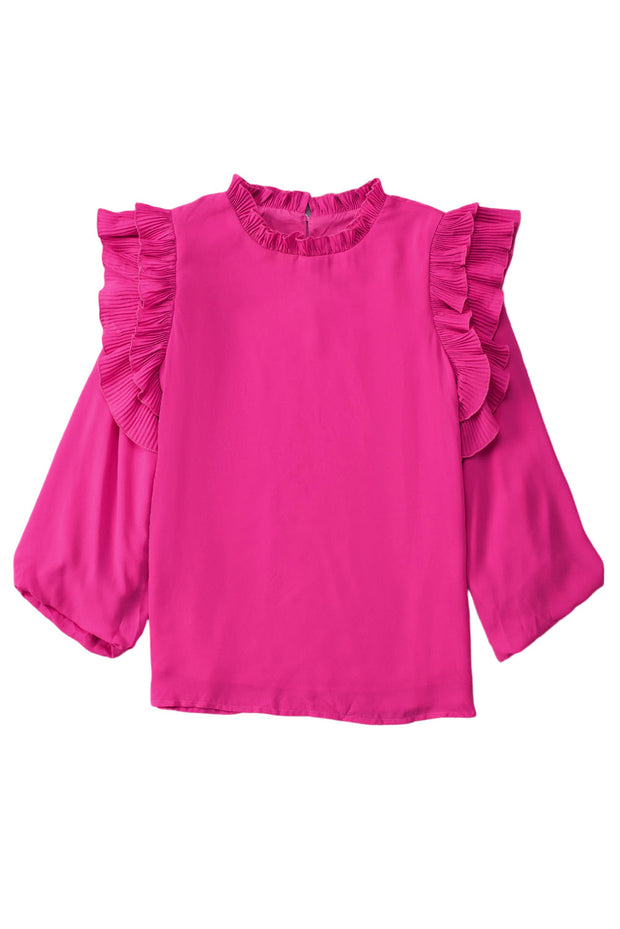a pink top with ruffles on the shoulders