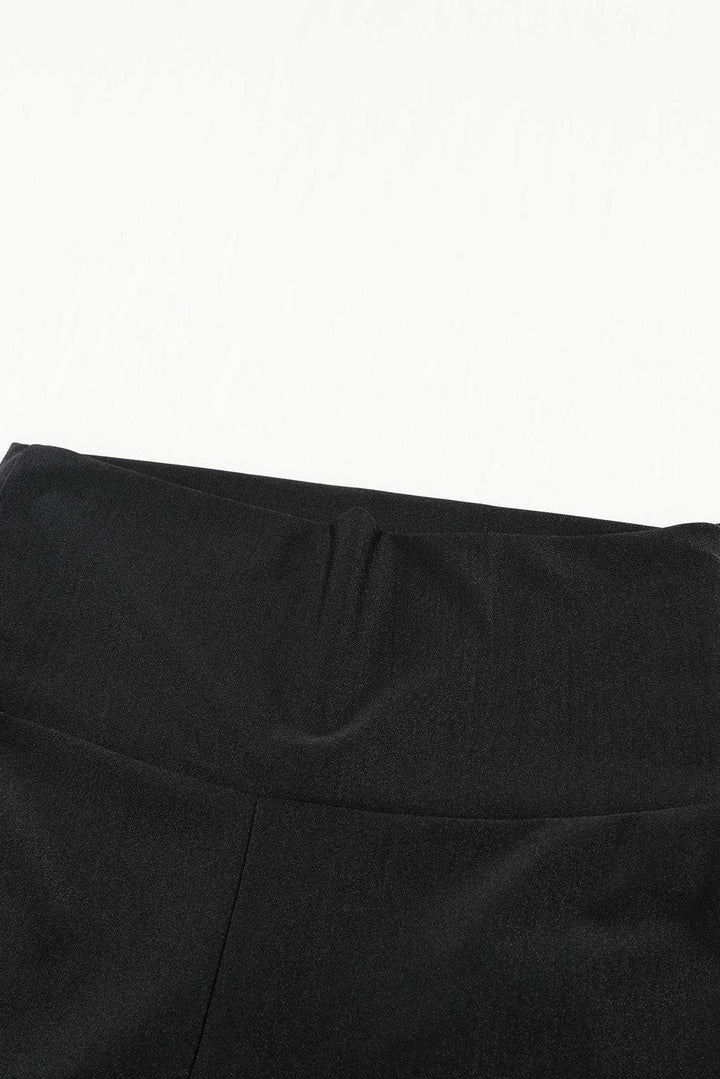 a close up of a black pants with a white background