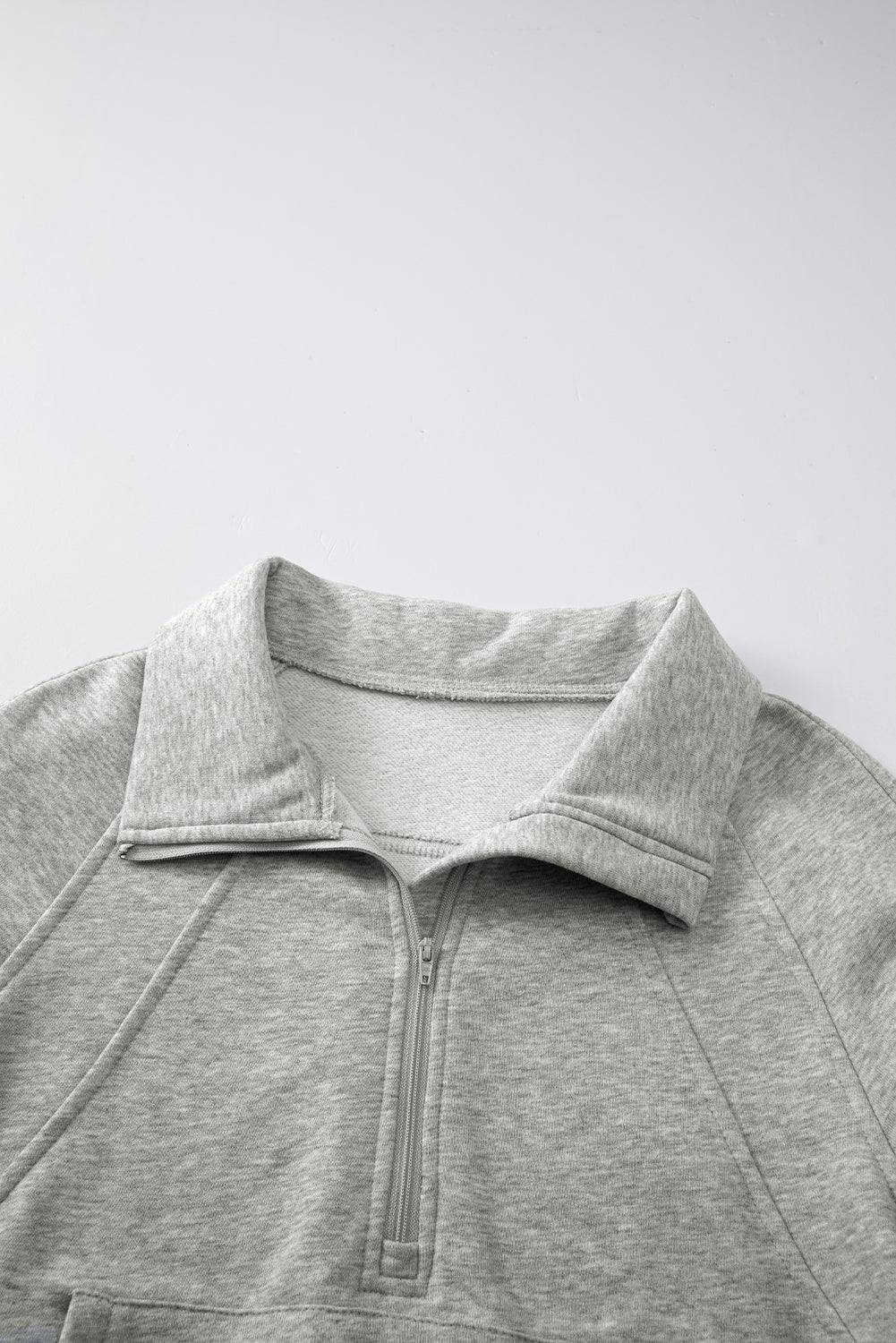 a close up of a gray sweatshirt on a white background