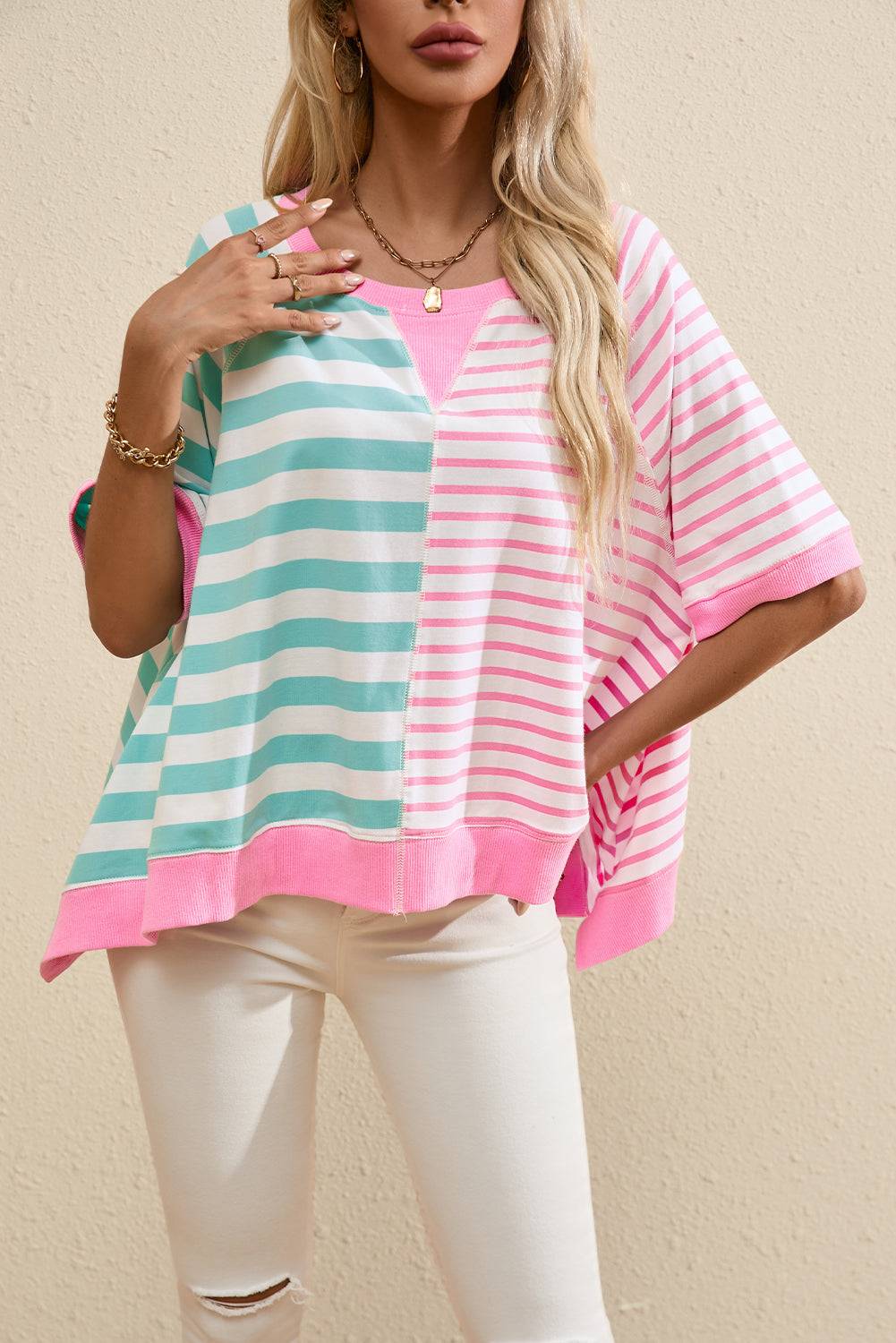 a woman wearing a pink and blue striped top
