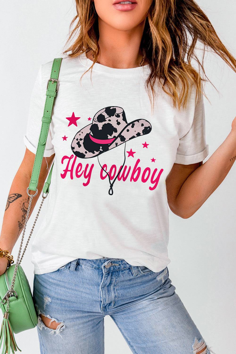 a woman wearing a tee shirt that says hey cowboy