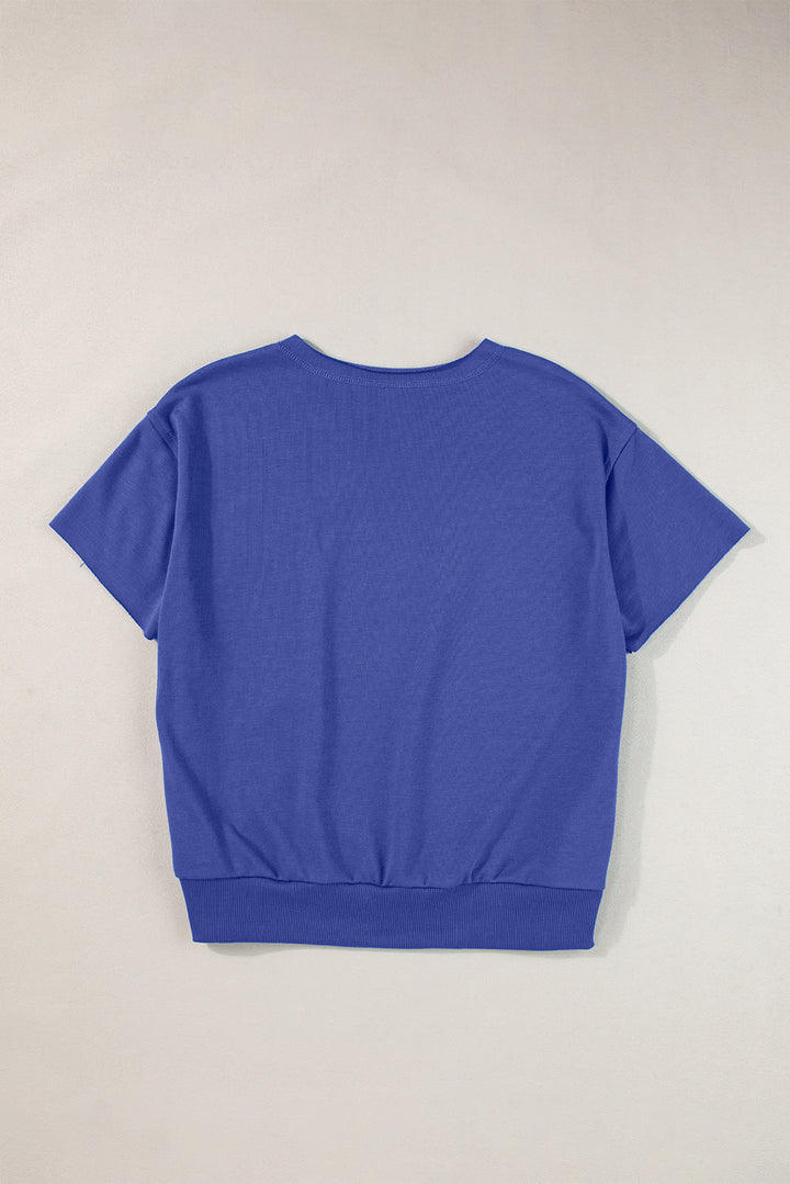 a blue t - shirt hanging on a wall