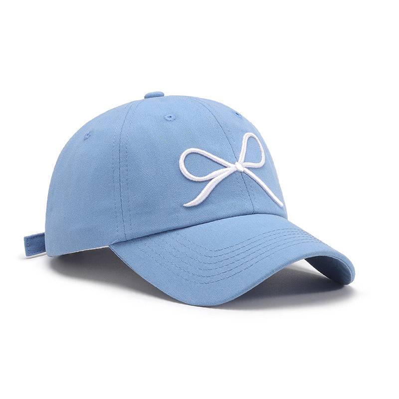 a light blue hat with a white bow on it