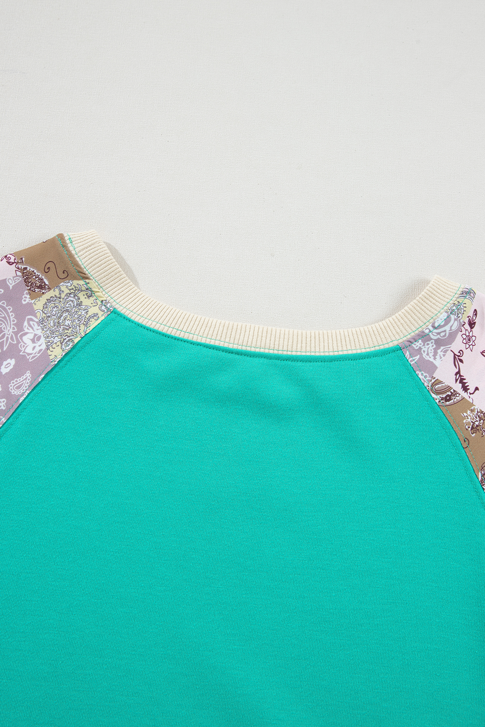 Close-up of neckline on Aruba Blue Plaid Vintage Paisley Patchwork Long Sleeve Raglan Top with ribbed trim. Shop at Faith & Co. Boutique.