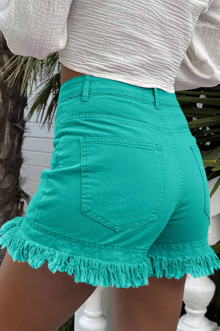 a close up of a person wearing green shorts