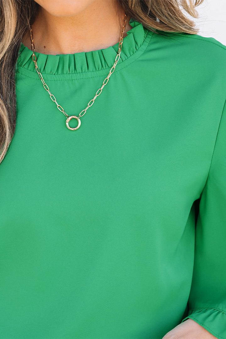 Detailed neckline view of Green Frilly Round Neck Wide Half Sleeve Blouse with gold necklace, perfect for accessorizing.