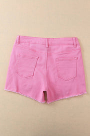 a pair of pink shorts hanging on a wall