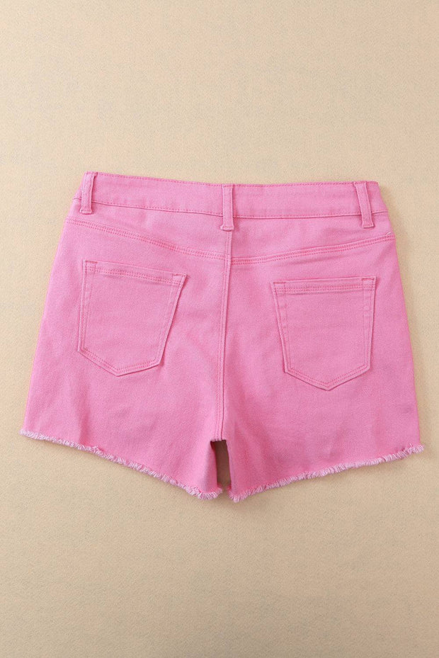 a pair of pink shorts hanging on a wall