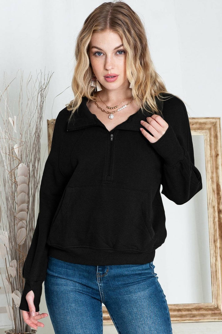 a woman wearing a black sweater and jeans