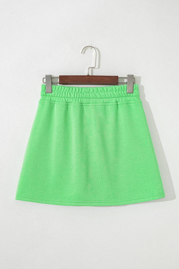 Back flat lay of light green French Terry mini skort showing clean design and elastic waistband, perfect for summer style at Faith & Co. Boutique.