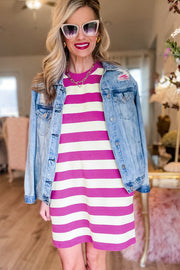 a woman wearing a pink and white striped dress