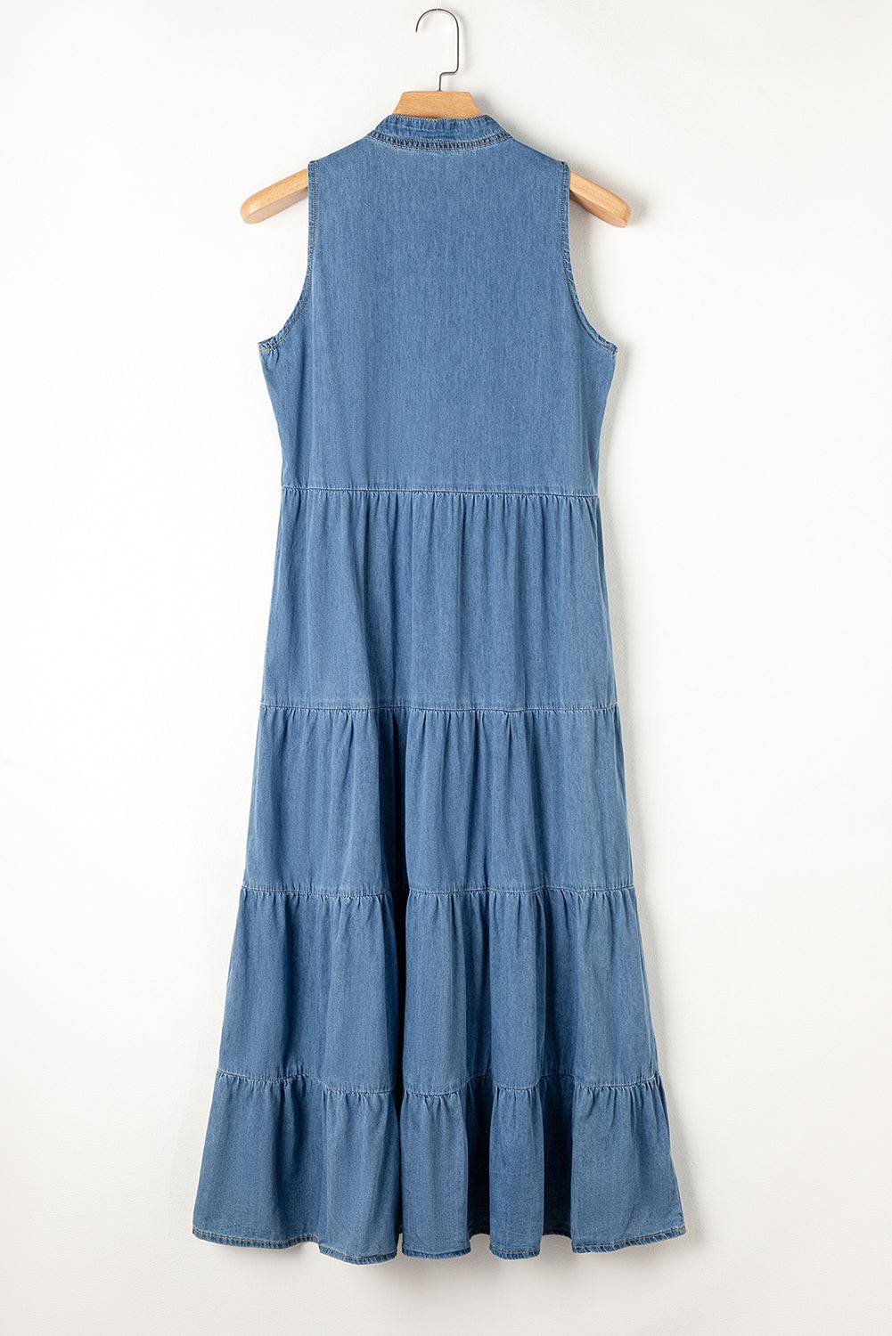 a blue dress hanging on a wooden hanger