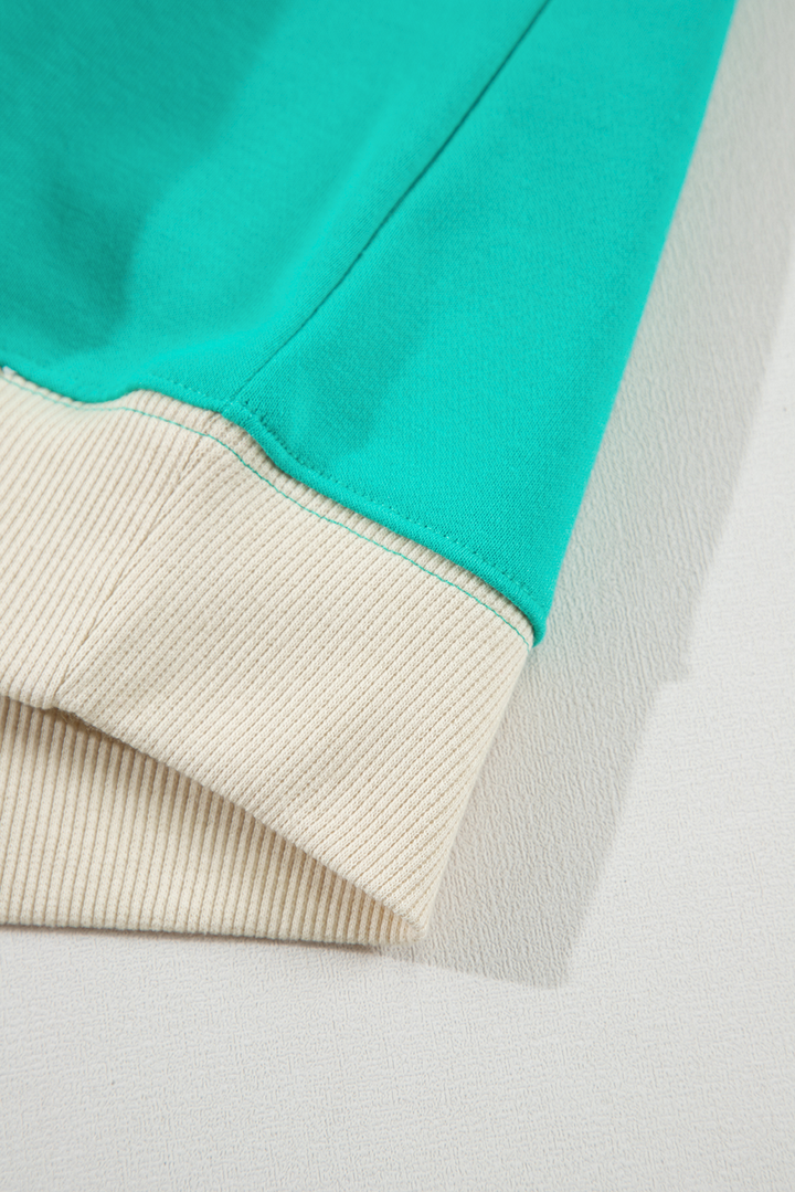 Bottom hem detail of Aruba Blue Plaid Vintage Paisley Patchwork Long Sleeve Raglan Top with ribbed trim. Shop at Faith & Co. Boutique.