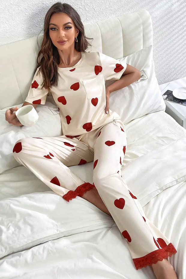 a woman sitting on top of a bed in pajamas
