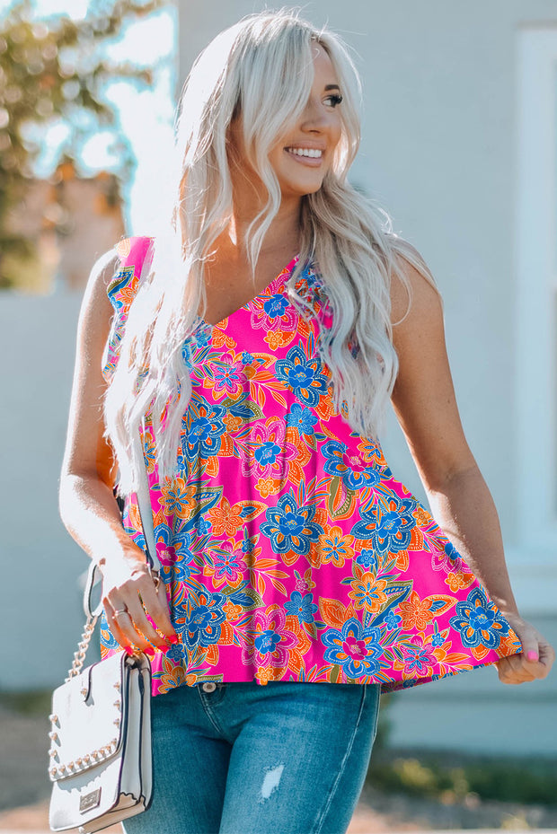 a woman wearing a pink and blue floral top