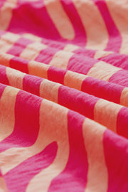 a close up of a pink and white blanket