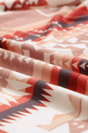 a close up of a red and white blanket