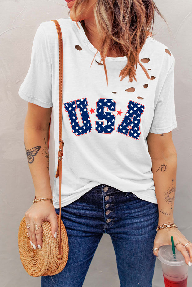 a woman wearing a usa t - shirt and holding a straw hat