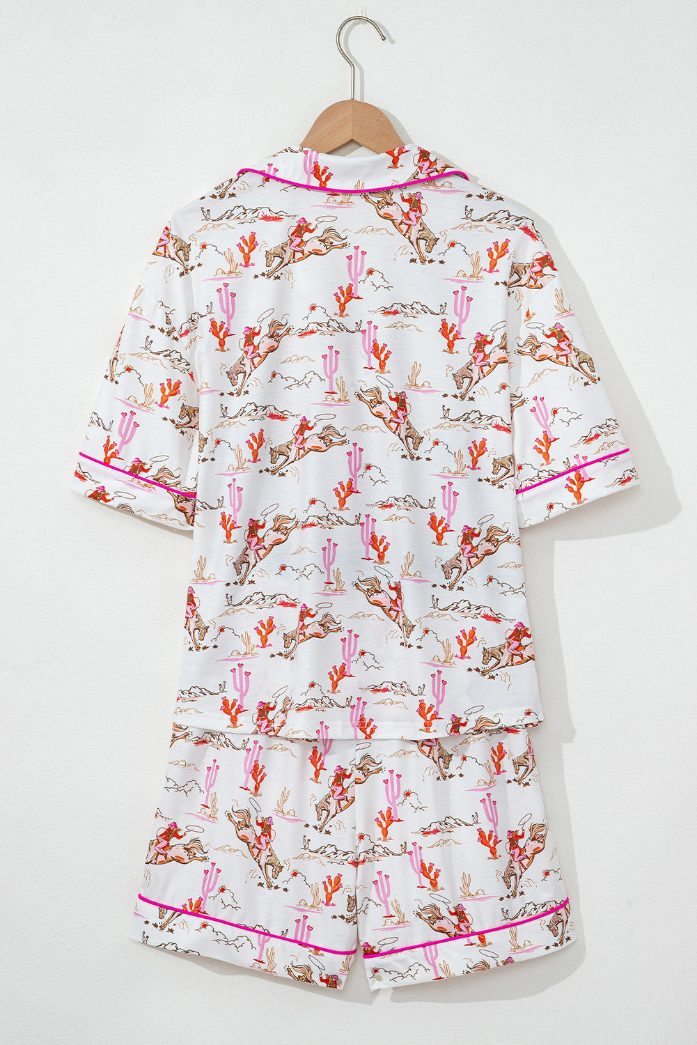 Close-up of pajama shorts from White Cowgirl Country Print Pajamas Set with cowgirl and cactus design. Shop White Cowgirl Country Print Pajamas Set at Faith & Co. Boutique.