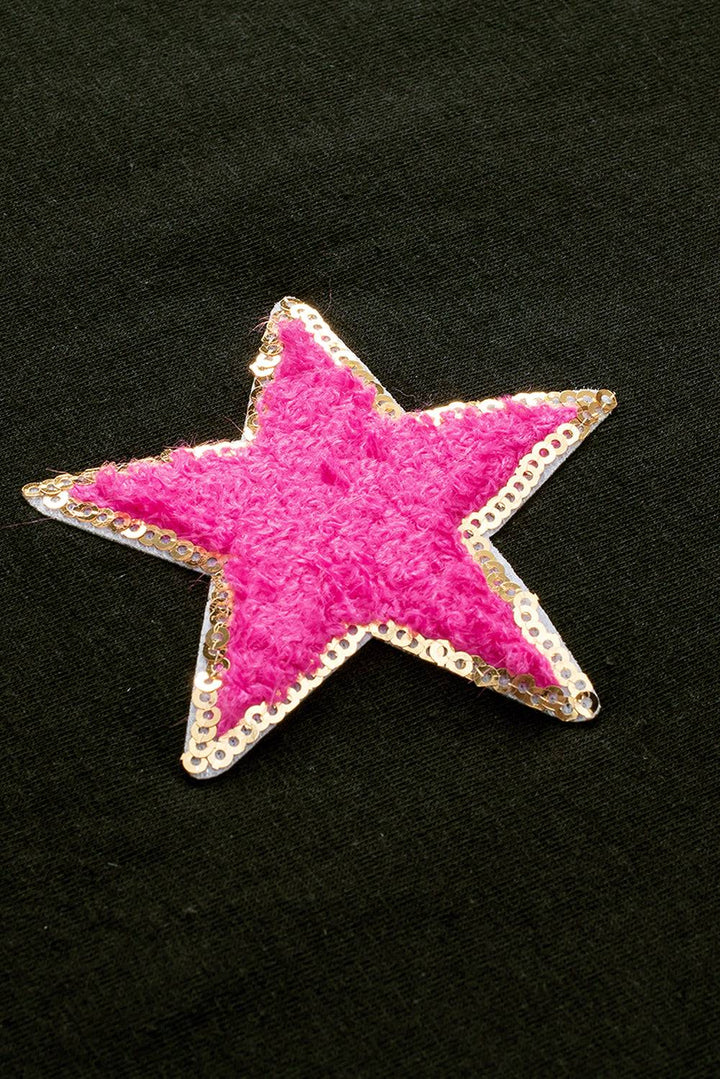 a pink star on a black background