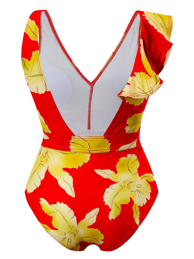 a woman in a red and yellow floral print swimsuit