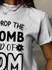 a woman wearing a t - shirt that says drop the bomb and off mom