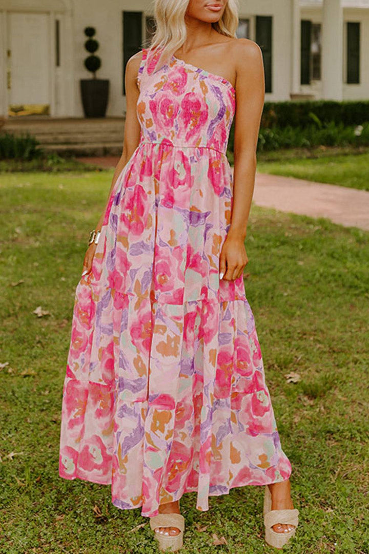 Pink Abstract Floral Print Shirred One Shoulder Maxi Dress with A-line silhouette, perfect for summer weddings or vacations. Shop at Faith & Co. Boutique.