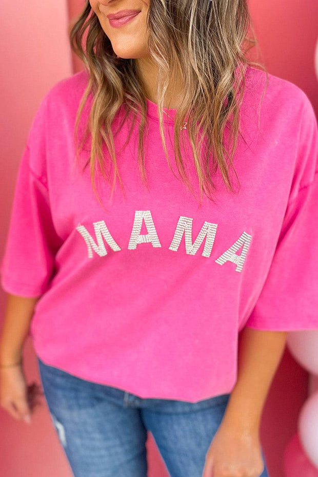 a woman wearing a pink shirt with the word mama on it