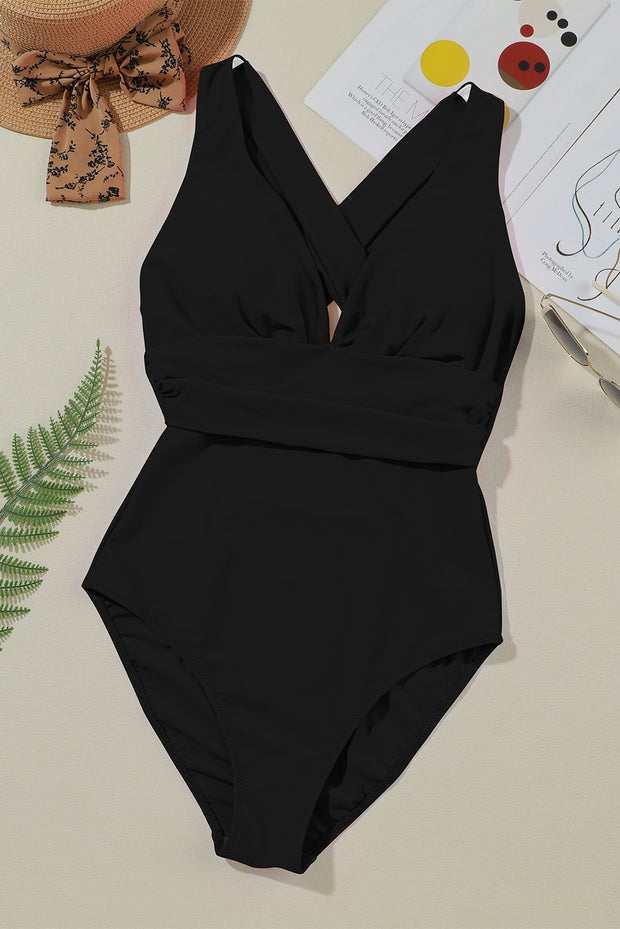 a black one piece swimsuit sitting on top of a table