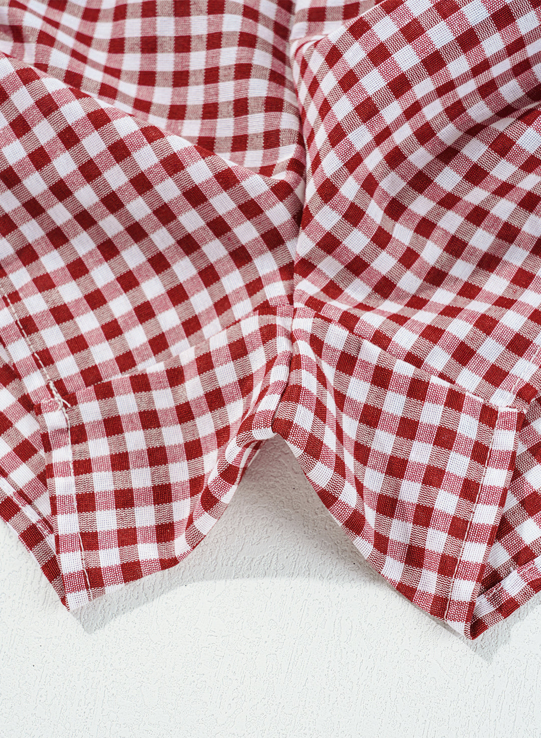 Fabric close-up of Red Plaid Gingham Printed High Waist Shorts highlighting breathable cotton texture. Shop comfy casual shorts at Faith & Co. Boutique.