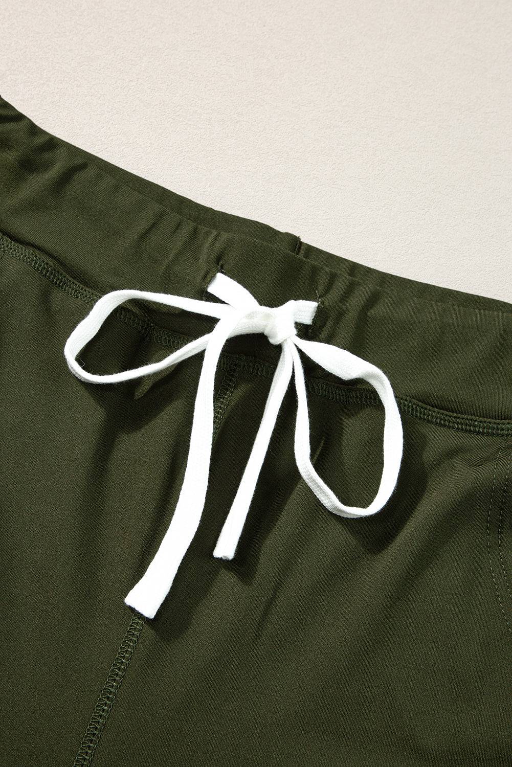 a close up of a pair of green pants with a white tie