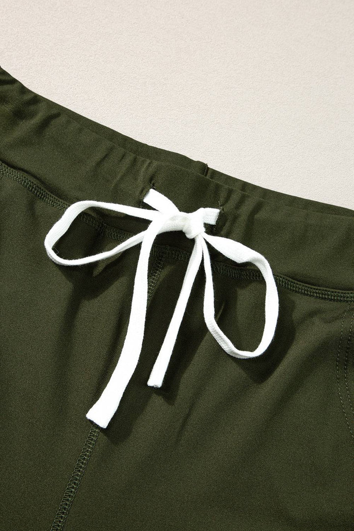 a close up of a pair of green pants with a white tie