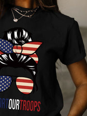 a woman wearing a black t - shirt with an american flag on it
