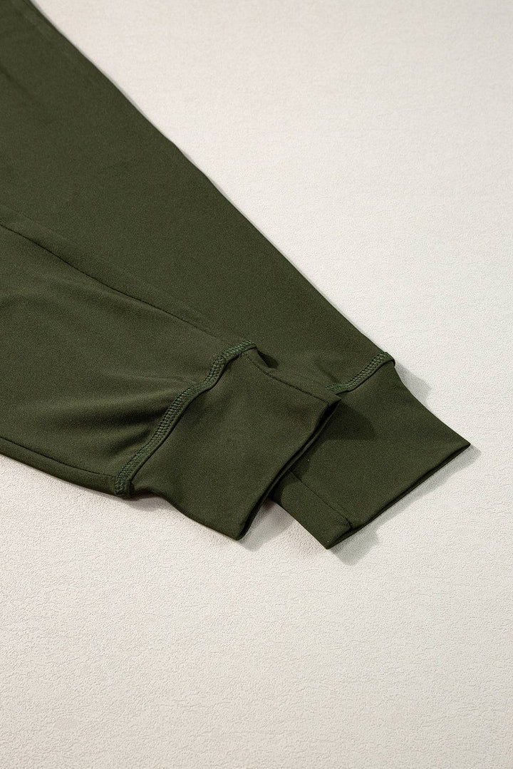 a pair of green pants laying on top of a white surface