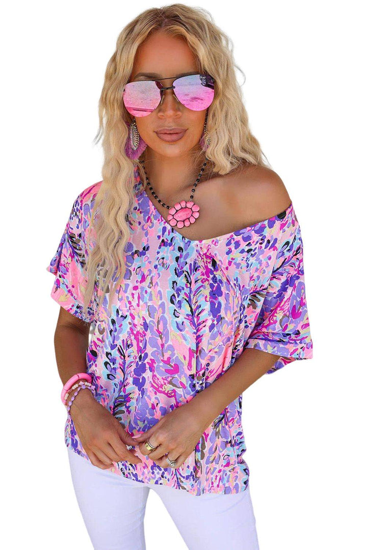 a woman wearing sunglasses and a pink top