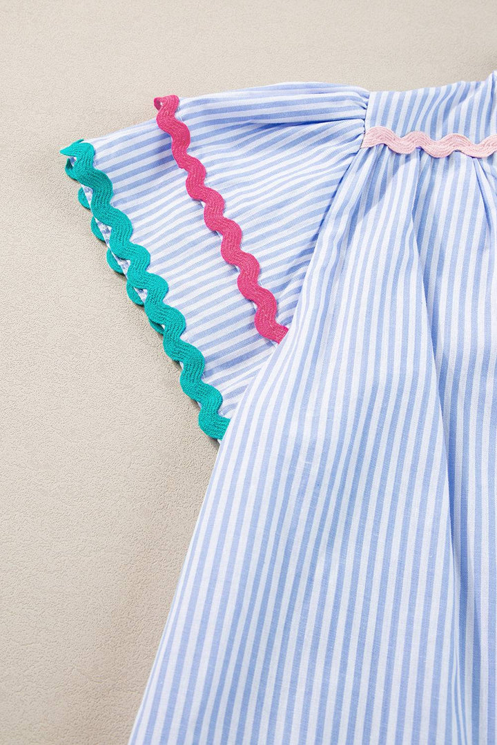 a blue and white striped dress with pink trim